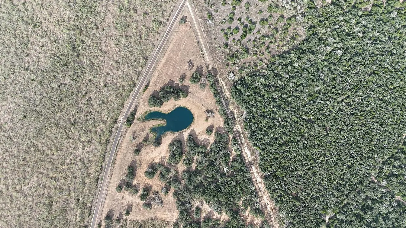 Top down drone view of ranch land along the road